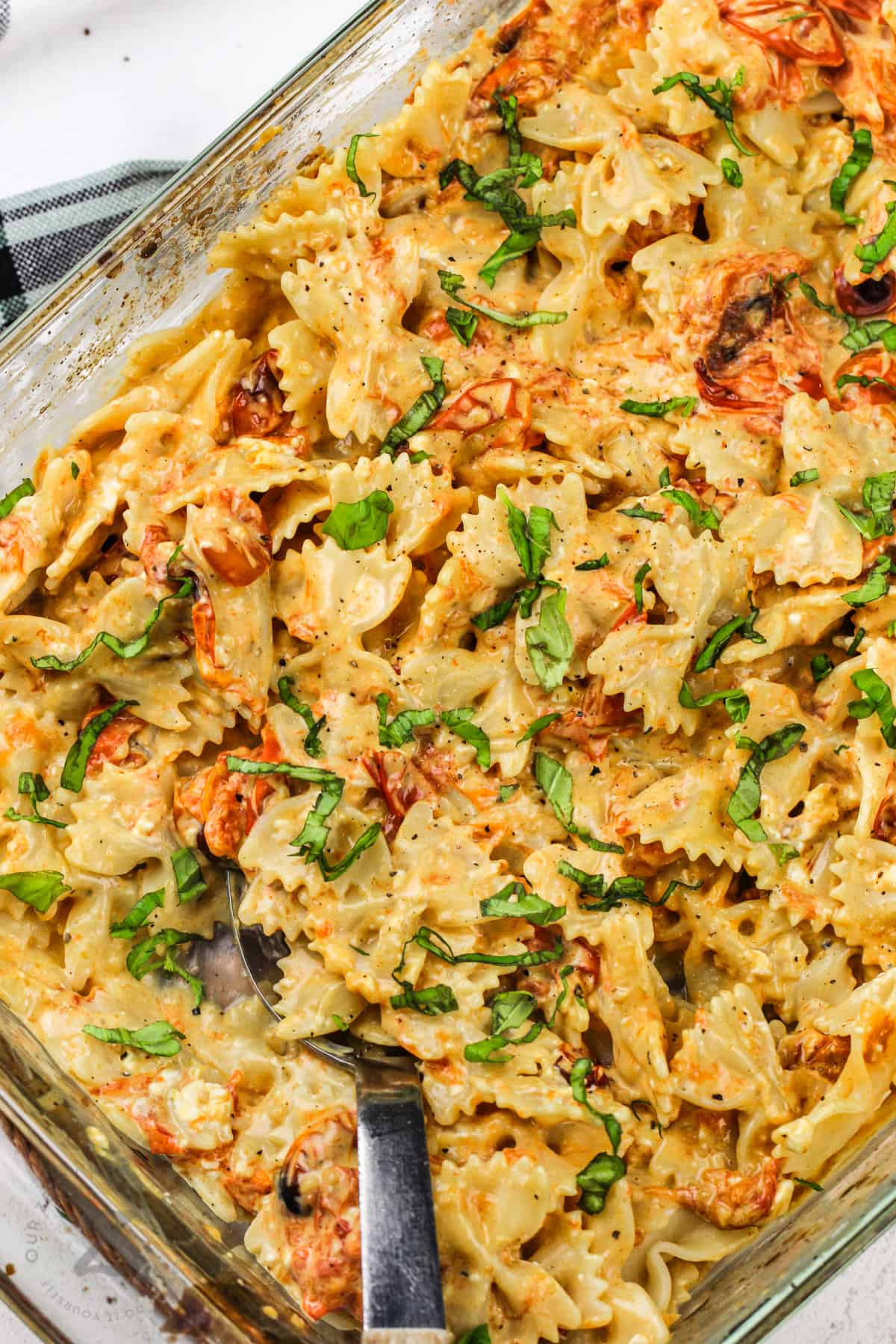 cooked Cream Cheese Tomato Pasta Bake with a spoon