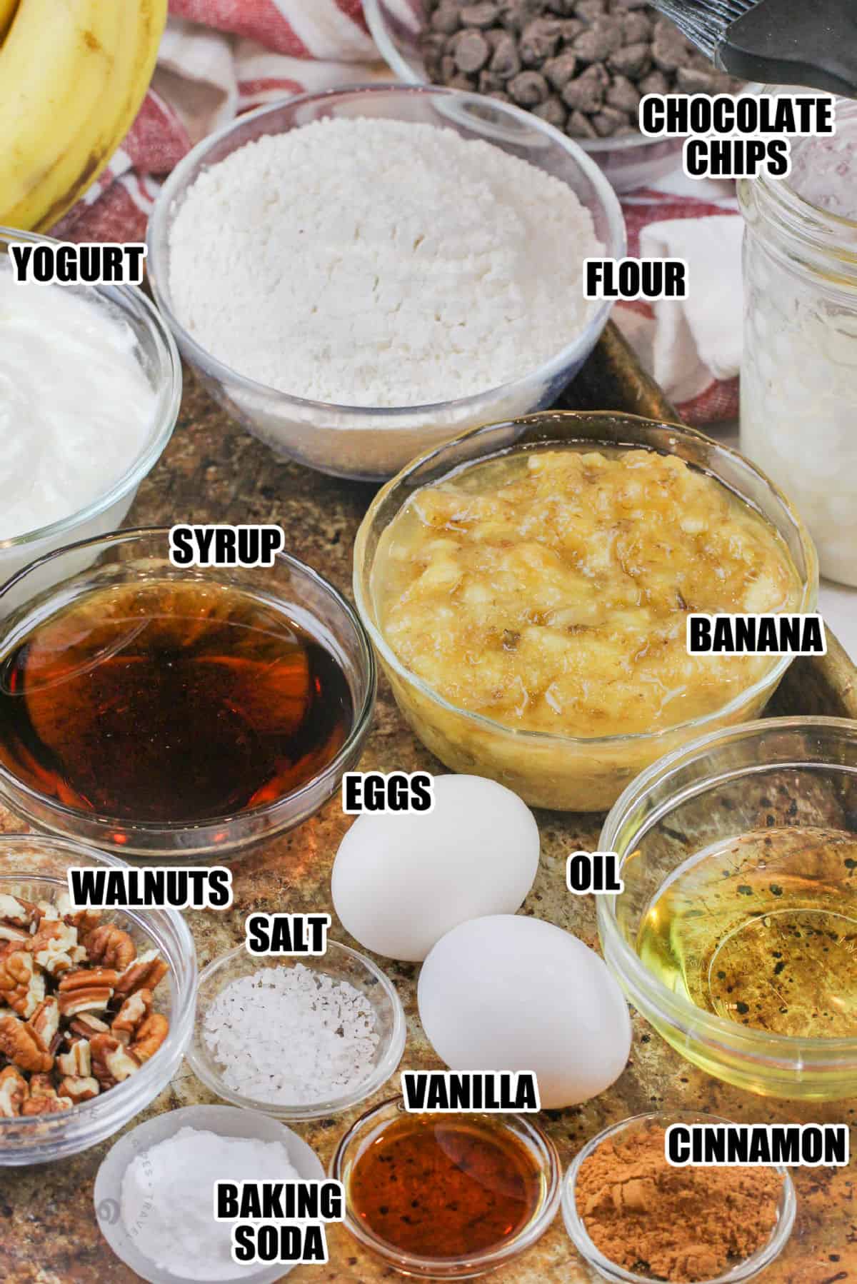 chocolate chips , flour , bananas , syrup , eggs , oil , walnuts and other ingredients to make Banana Muffins with labels