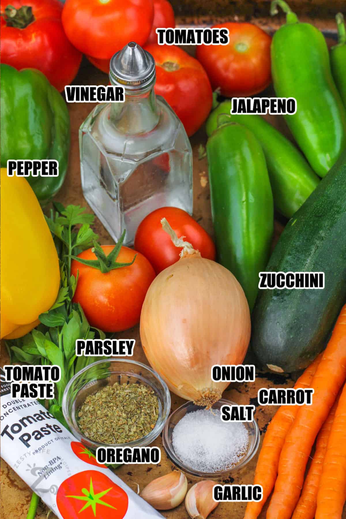 tomatoes , jalapeno , pepper , vinegar , zucchini , carrot , salt , onion , garlic , oregano , parsley and tomato paste to make Garden Salsa with labels