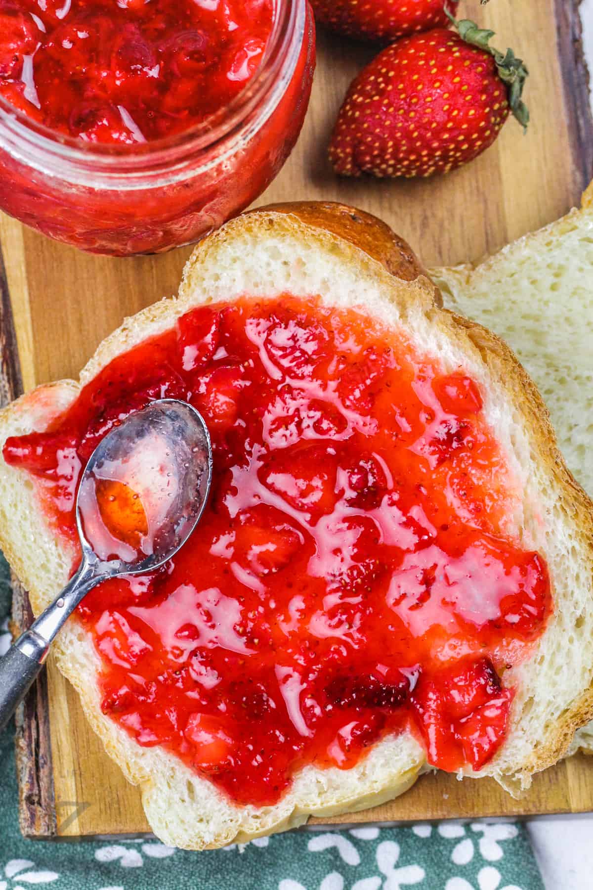 putting Strawberry Freezer Jam Recipe on bread