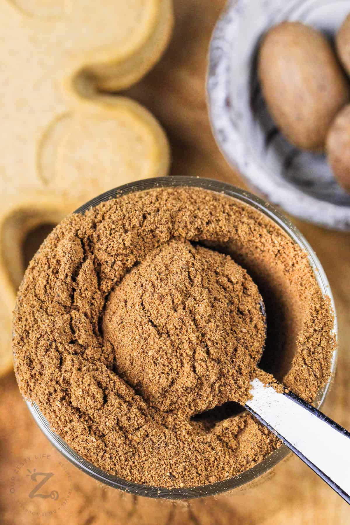 jar of Gingerbread Spice with gingerbread cookie in the back