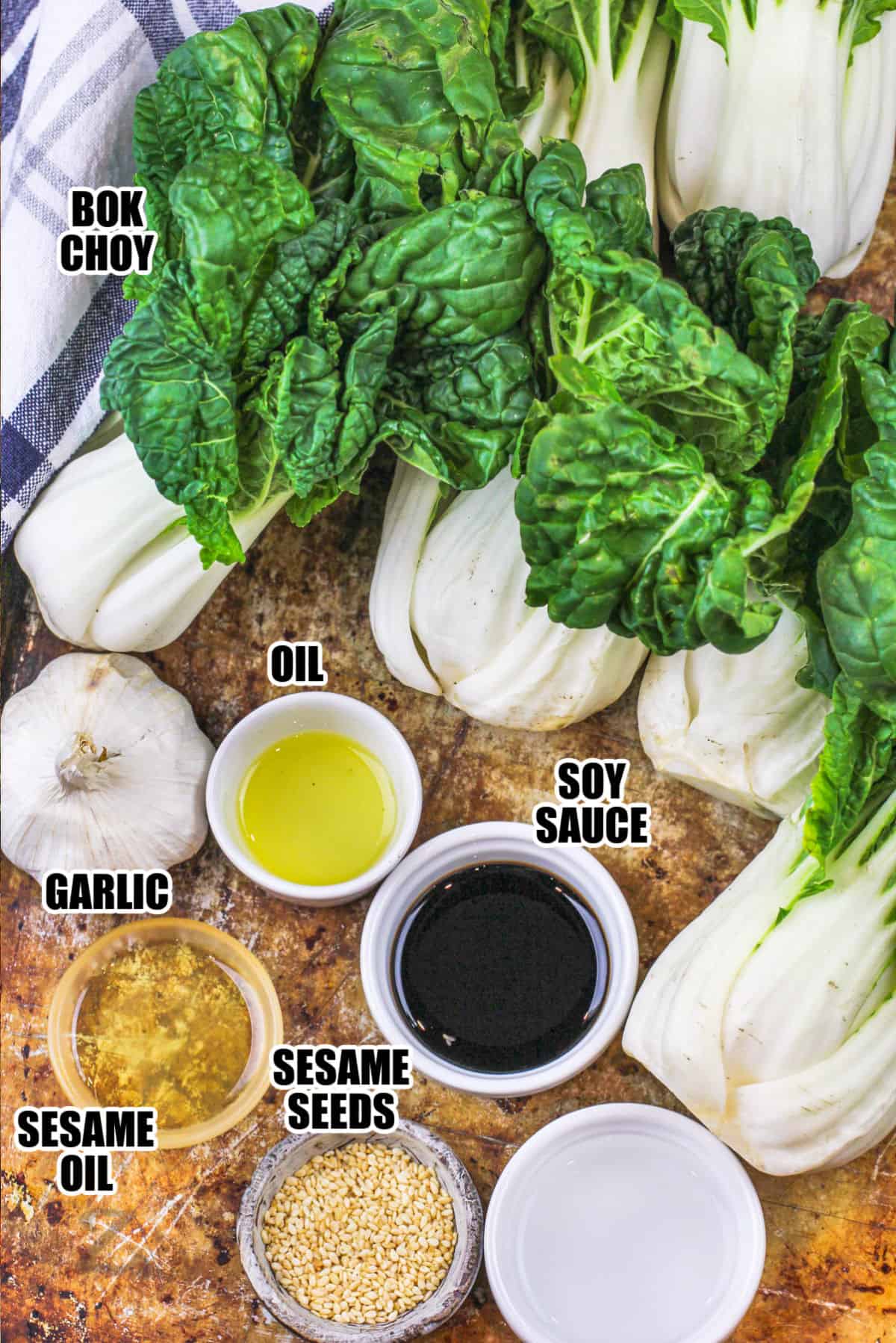 bok choy, oil, soy sauce, garlic, sesame oil and sesame seeds assembled to make a garlic baby bok choy recipe