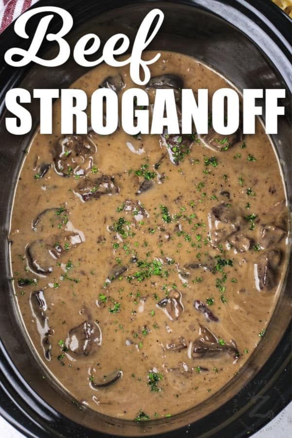 Slow Cooker Beef Stroganoff cooked in the pot with a title
