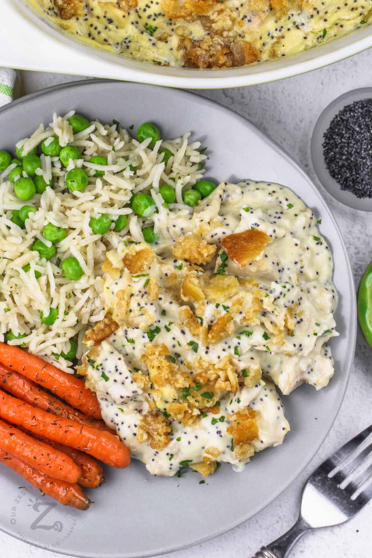 plated Easy Poppyseed Chicken with rice peas and carrots