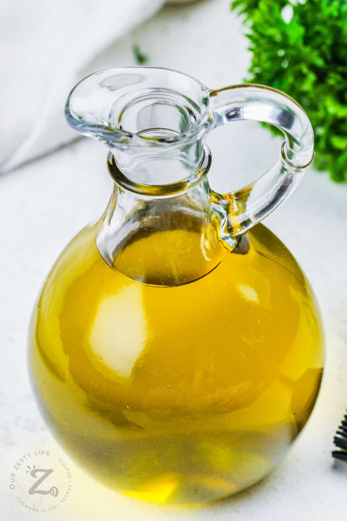 close up of Herb Infused Olive Oil in a jar