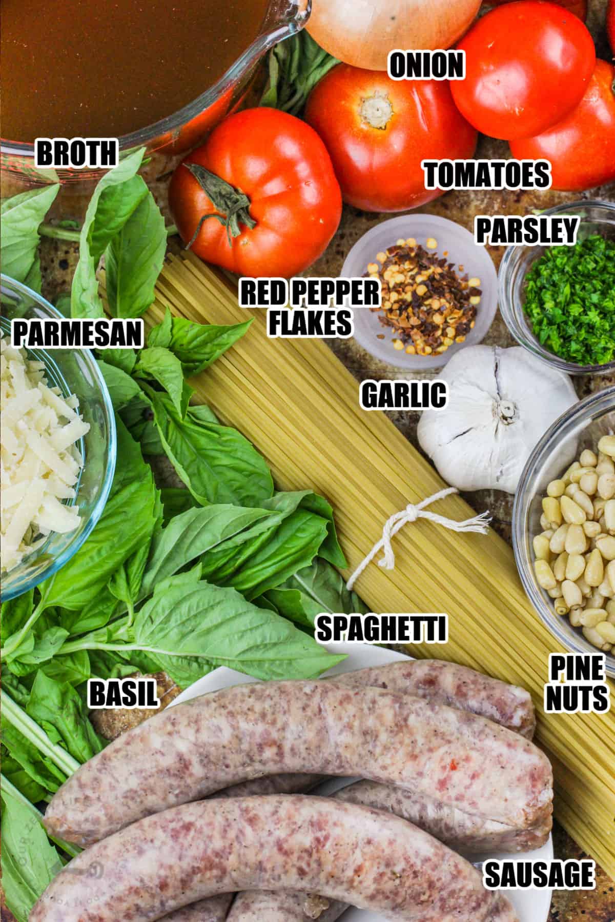 broth , onion , tomatoes , parsley , red pepper flakes , parmesan , garlic , pine nuts , spaghettit and sausage with labels to make Cheesy One Pot Pasta