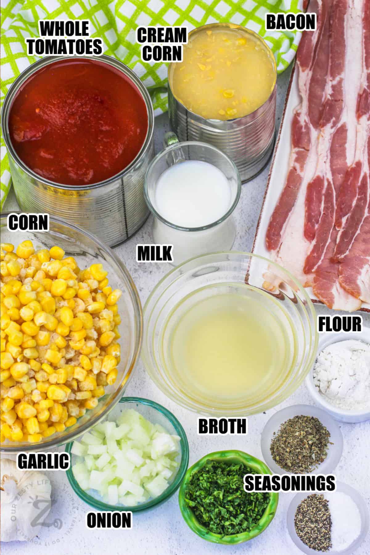 bacon , cream corn , whole tomatoes , milk , corn , broth , flour , seasonings , garlic and onion with labels to make Tomato Corn Chowder