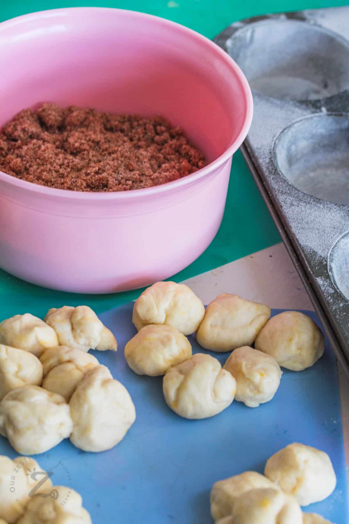 rolling Monkey Bread Muffins dough into balls
