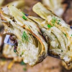 oven roasted fennel on a spatula garnished with fennel fronds