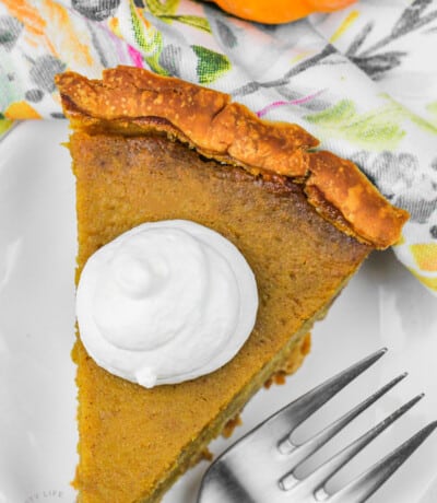 top view of Pumpkin Pie from Fresh Pumpkin slice on a plate with whipped cream