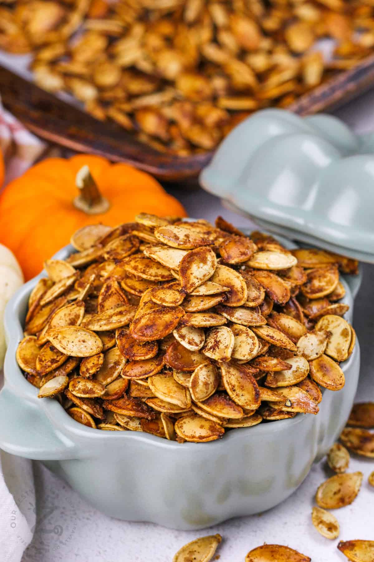 bowl of Pumpkin Spice Pumpkin Seeds with sheet pan in the back