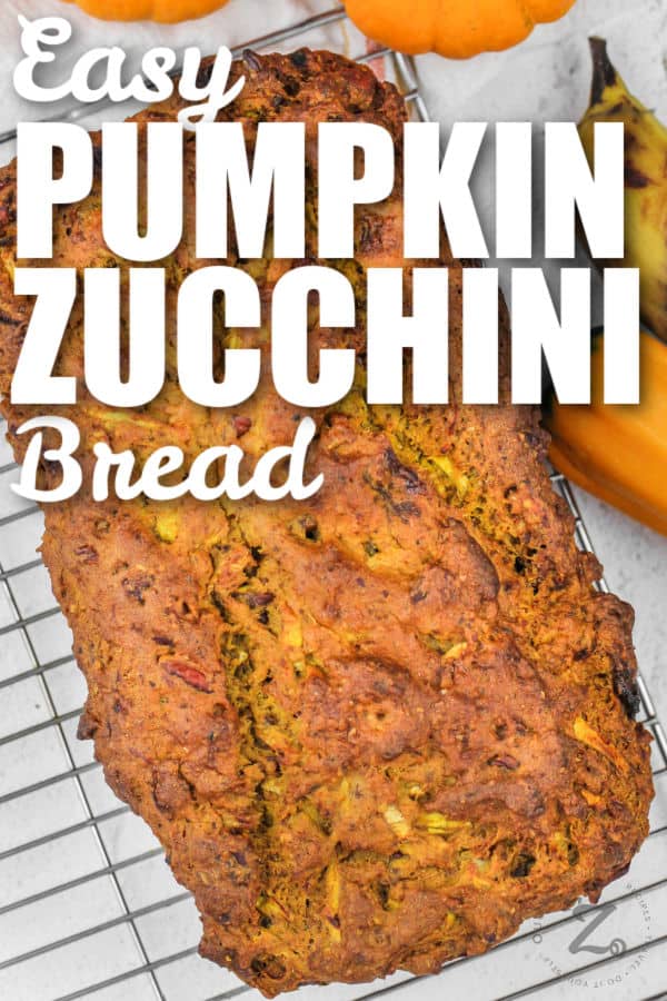 Pumpkin Zucchini Bread loaf on a cooling rack with writing