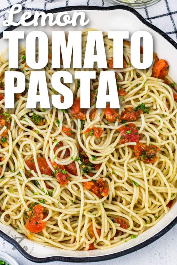 simple lemon tomato pasta in skillet with fresh parsley as garnish on top, with a title