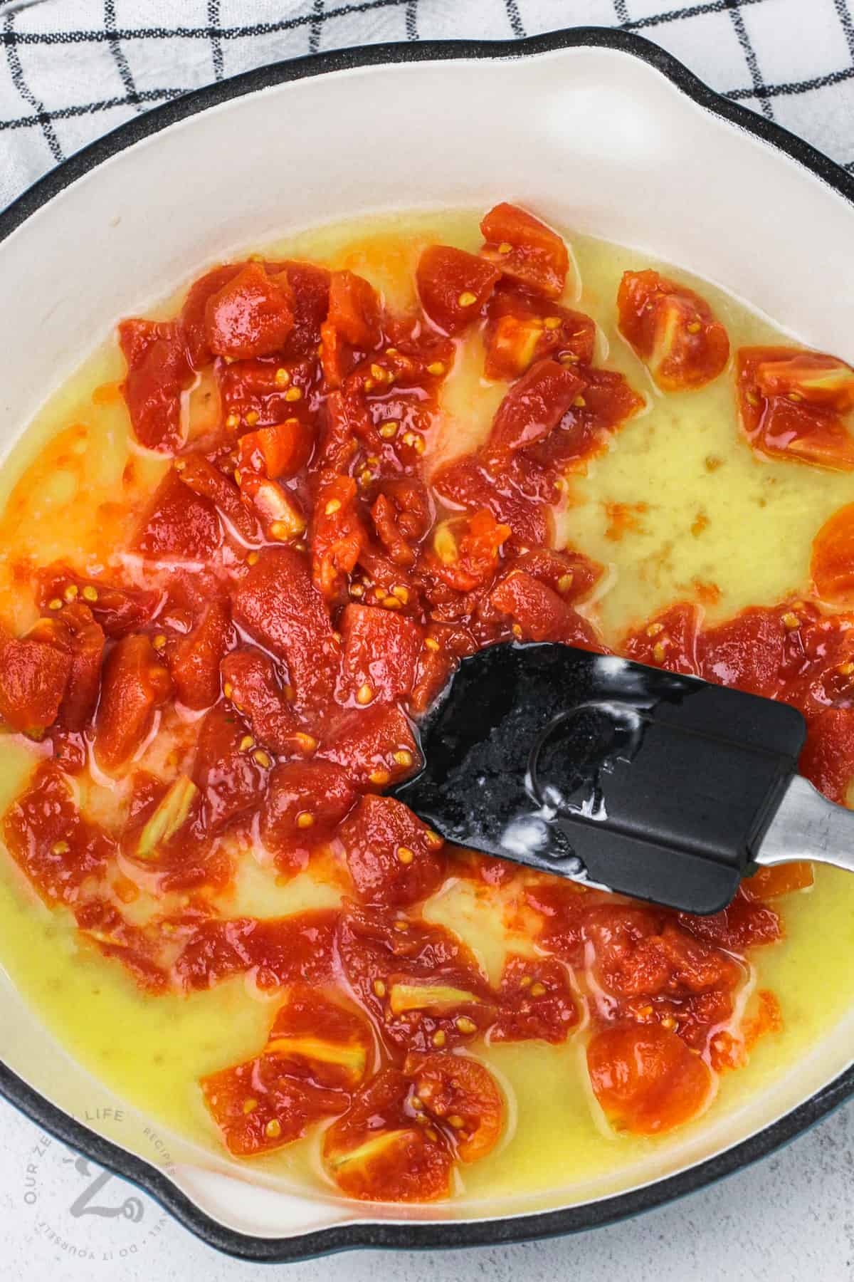 tomatoes and butter in a skillet, in preparation for simple lemon tomato pasta