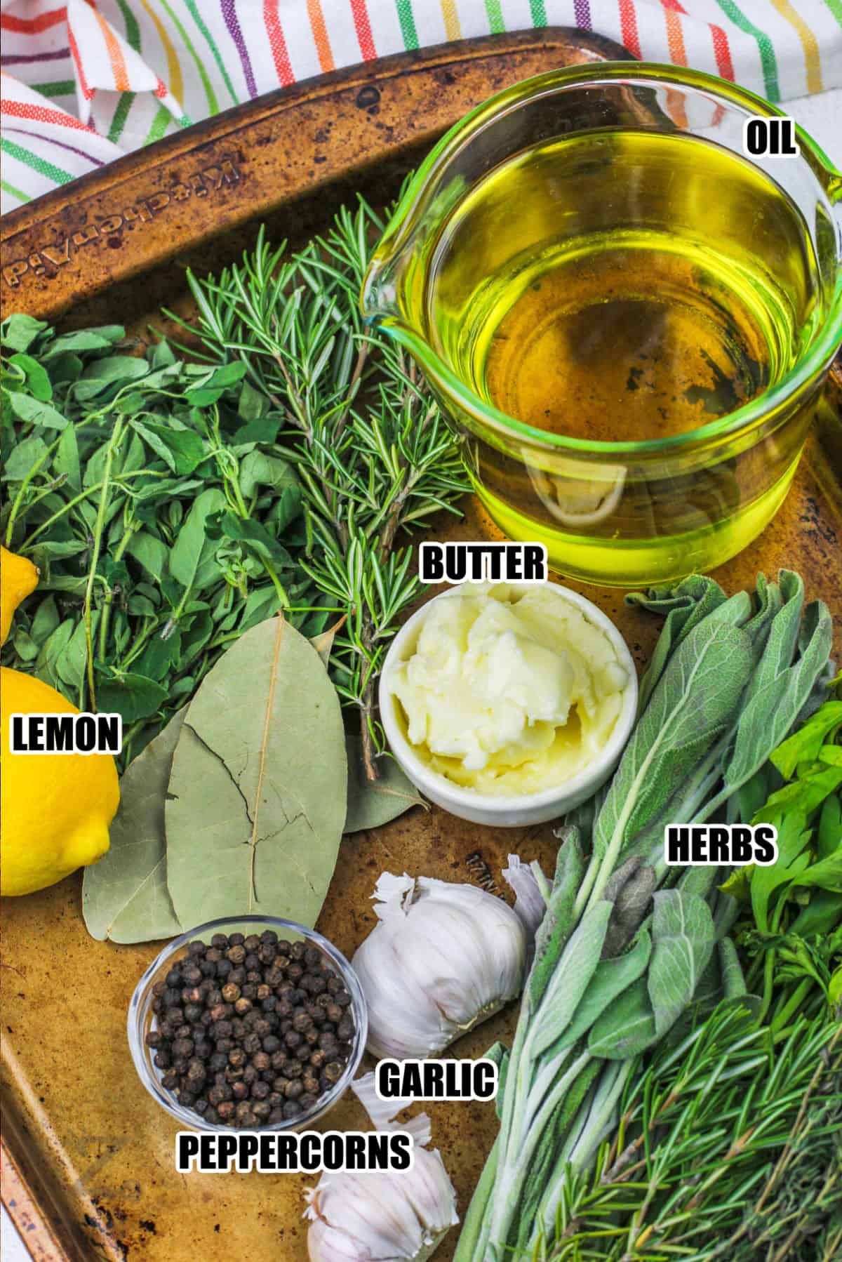 oil butter lemon , herbs garlic and peppercorns with labels to make Herb Infused Olive Oil