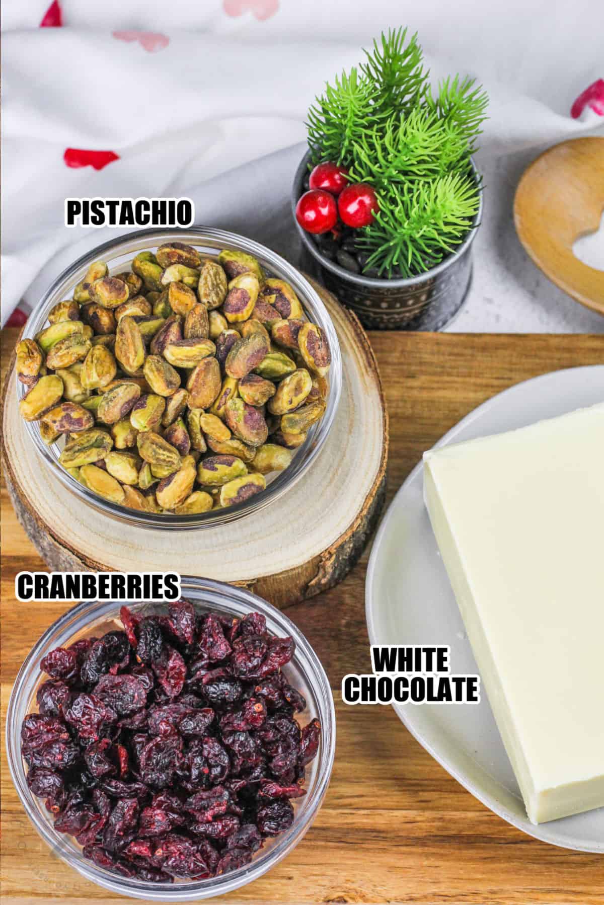 cranberries , pistachios , and white chocolate with labels to make White Chocolate Bark