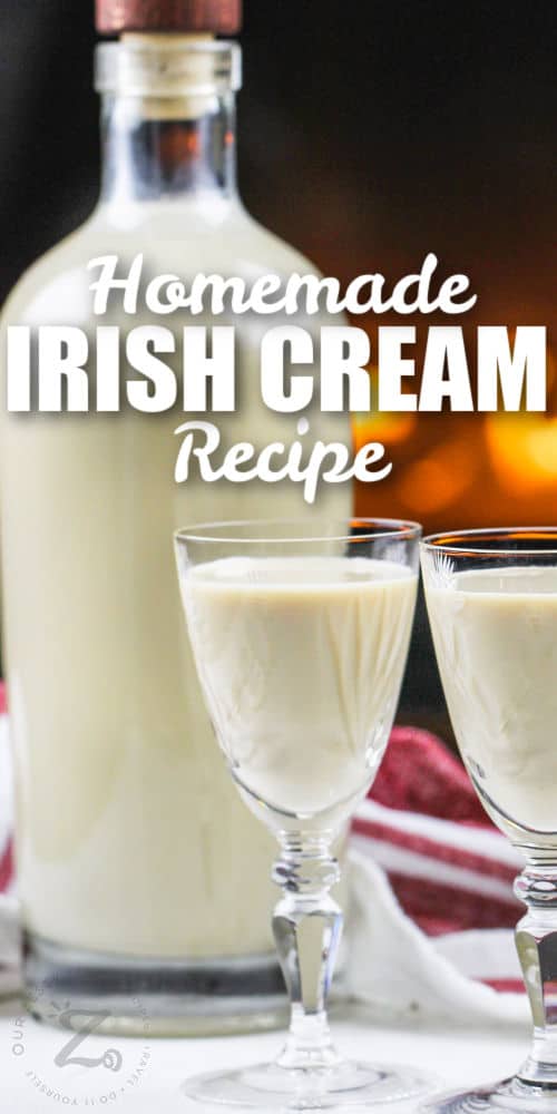 jar of Homemade Irish Cream with filled glasses and writing