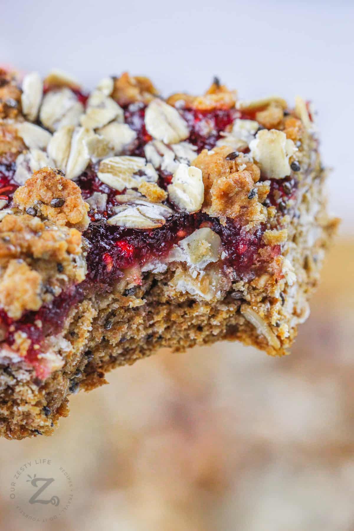 Raspberry Oat Bars with a bite taken out of a square