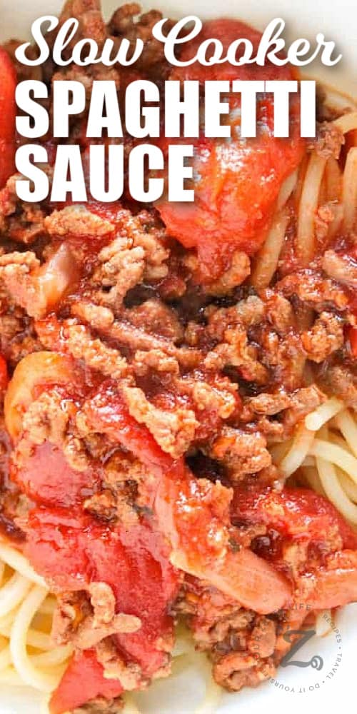 slow cooker spaghetti sauce, served over spaghetti, in a white bowl, with a title