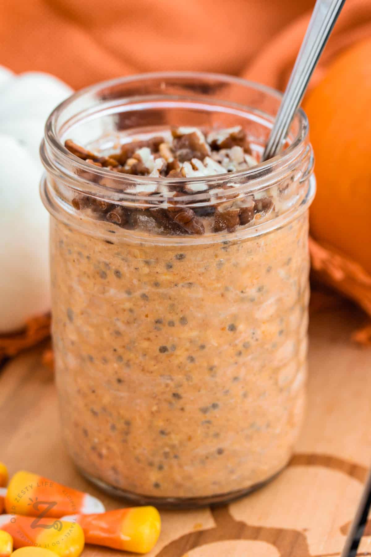 jar of Pumpkin Overnight Oats with walnuts and a spoon