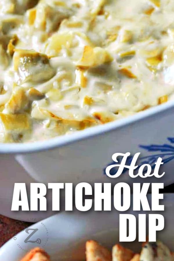 hot artichoke dip in a casserole dish with writing