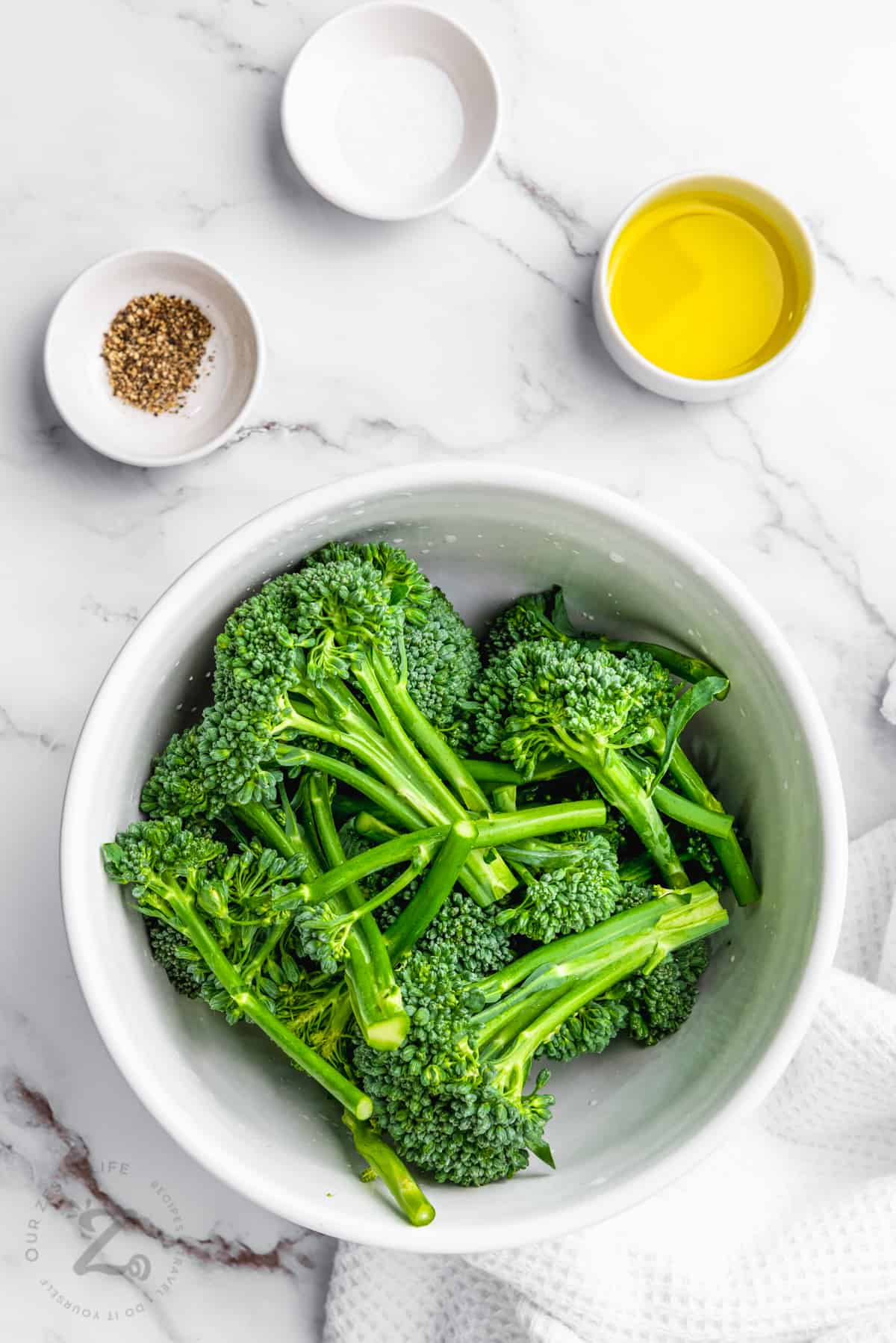 ingredients in bowls to make Air Fryer Broccolini