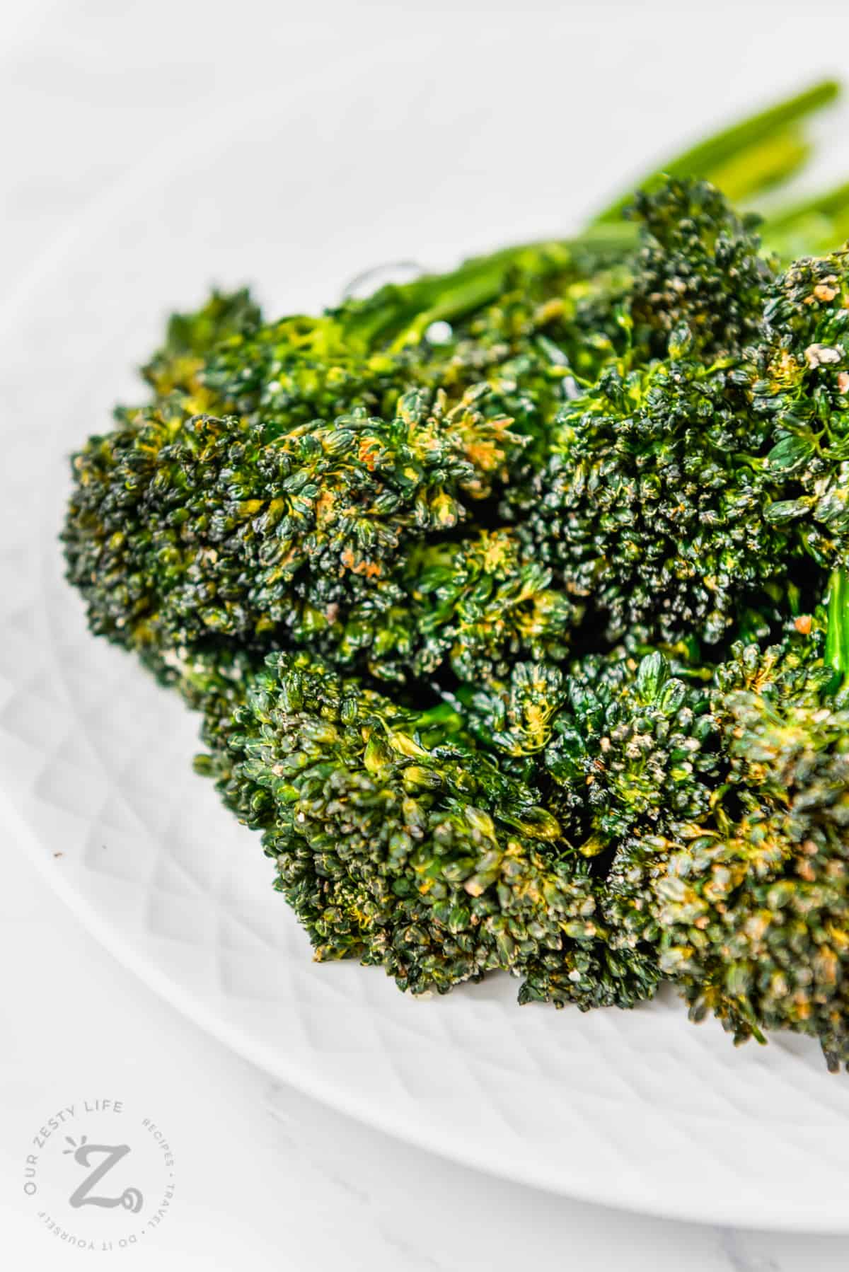 close up of cooked Air Fryer Broccolini on a plate