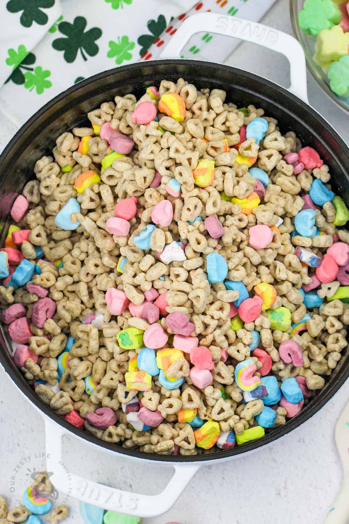 adding lucky charms to pot to make Lucky Charms Marshmallow Treats Squares