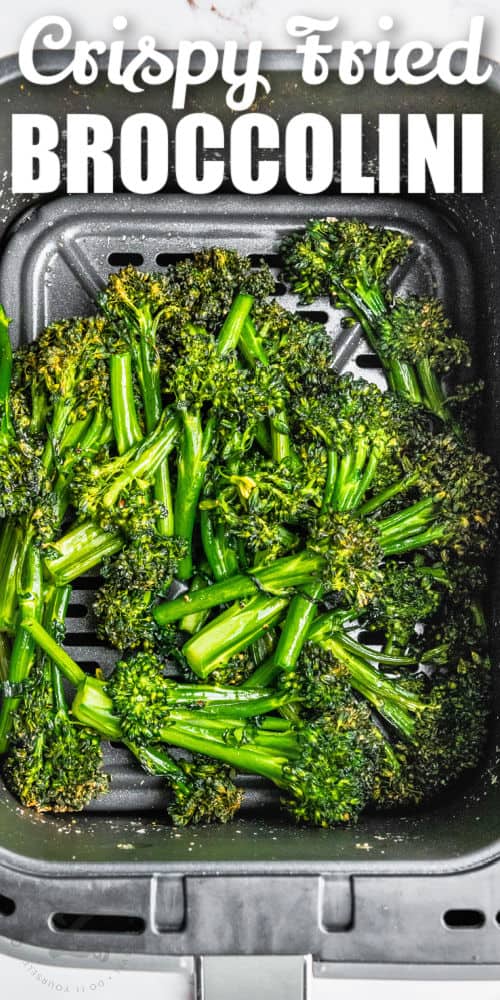 close up of Air Fryer Broccolini in the fryer with a title