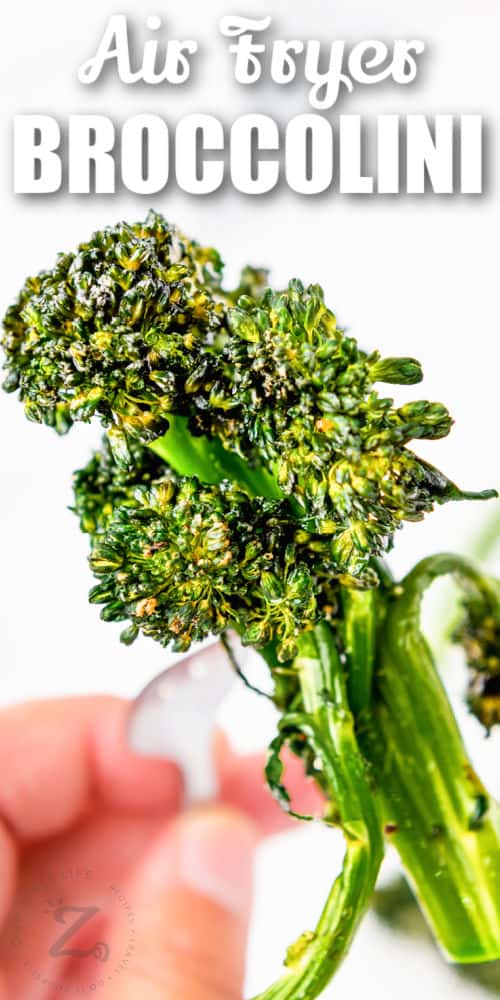 close up of Air Fryer Broccolini on a fork with a title