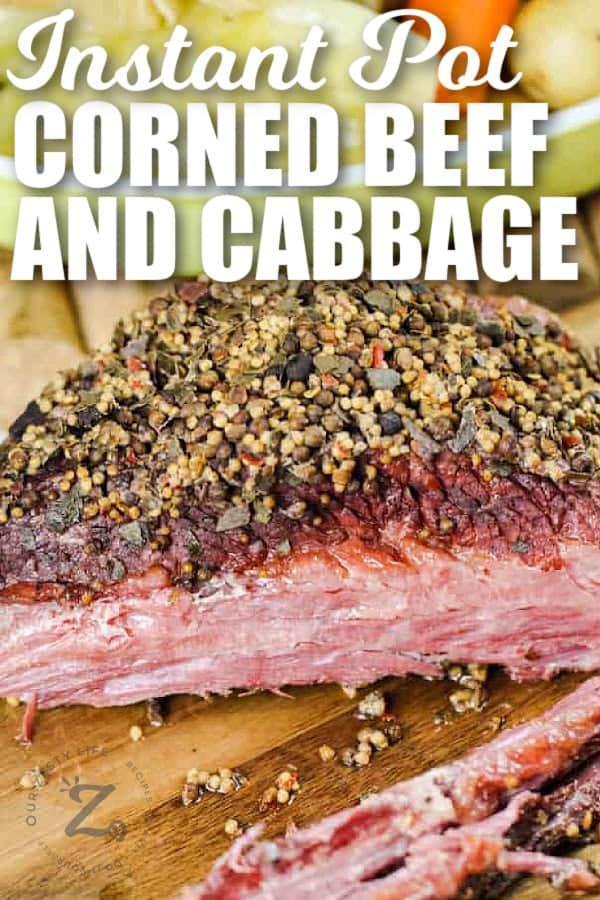 Instant Pot corned beef and cabbage with vegetables in a bowl in the background, with a title