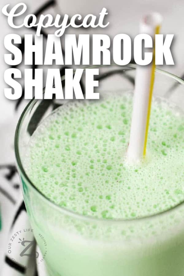 copycat shamrock shake in a clear glass with a straw, with a title
