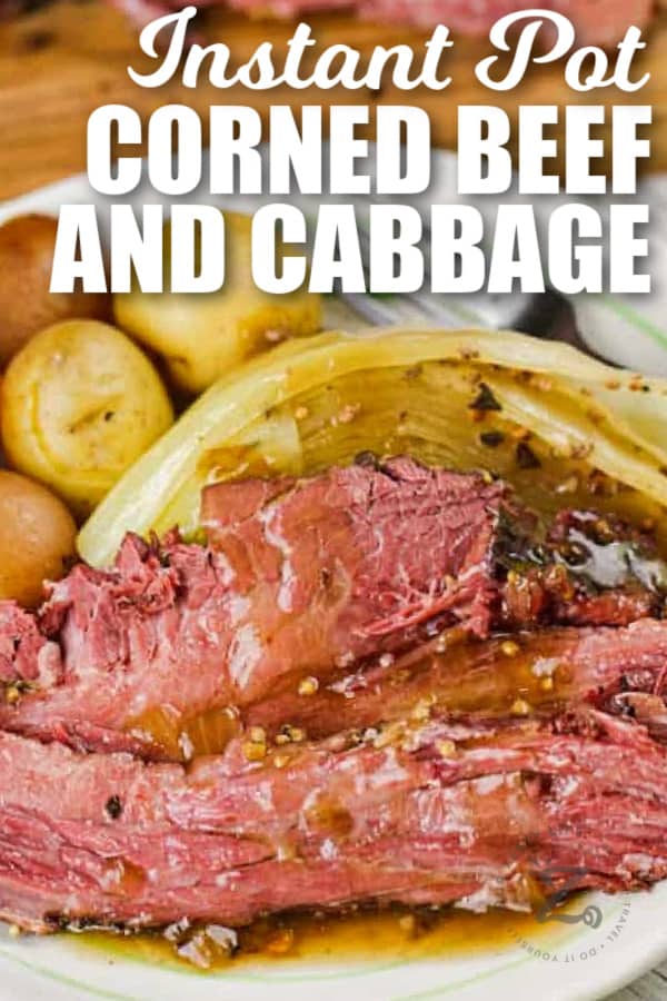 Instant Pot corned beef and cabbage served on a white plate with writing