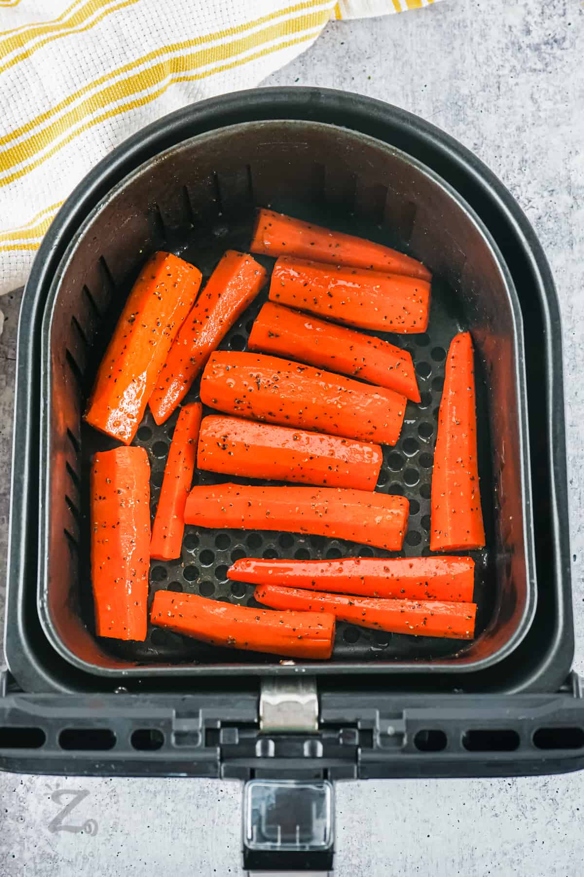 seasoned carrots in fryer to make Air Fryer Carrots