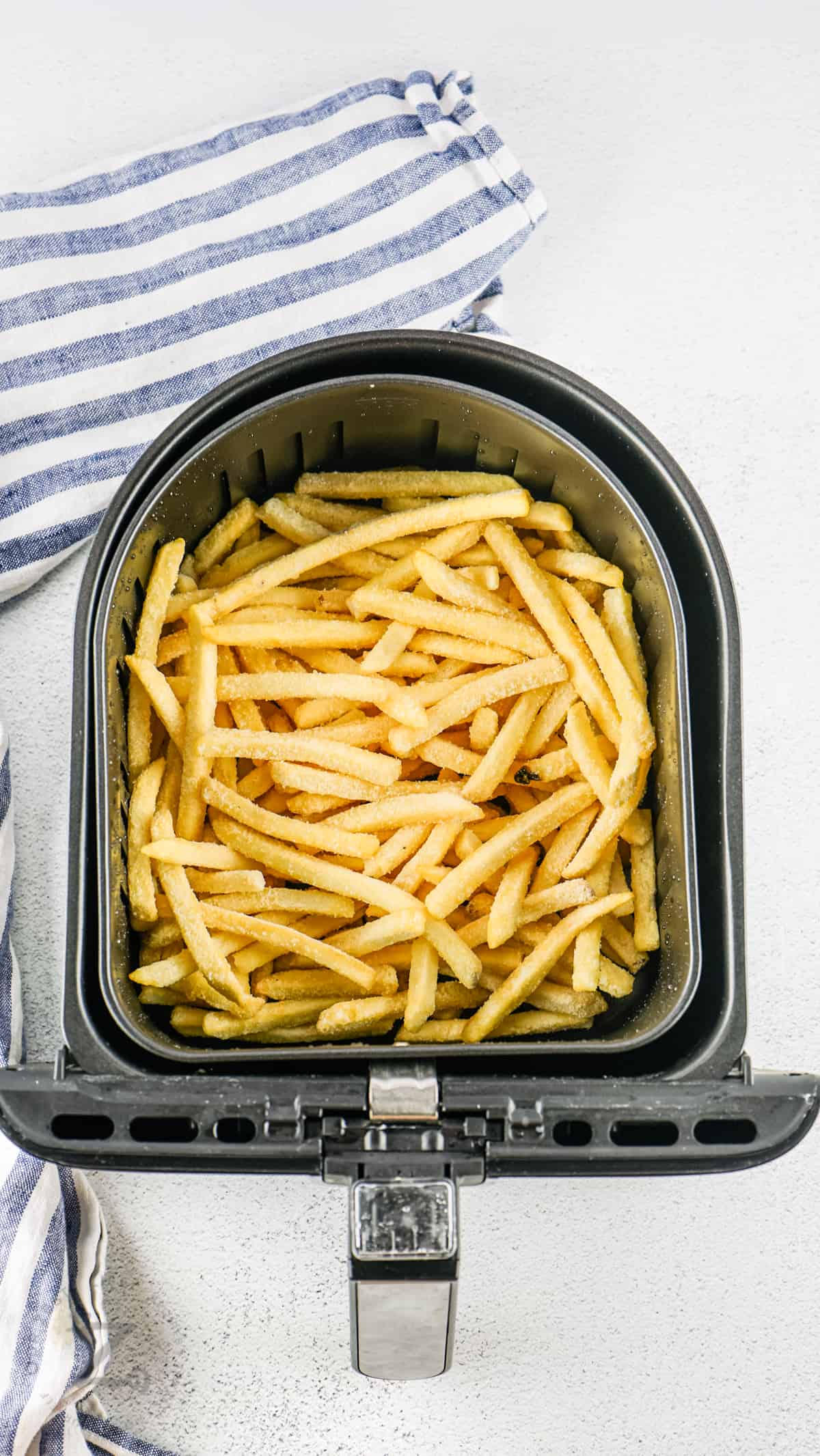 Air Fryer Frozen French Fries in the fryer before cooking