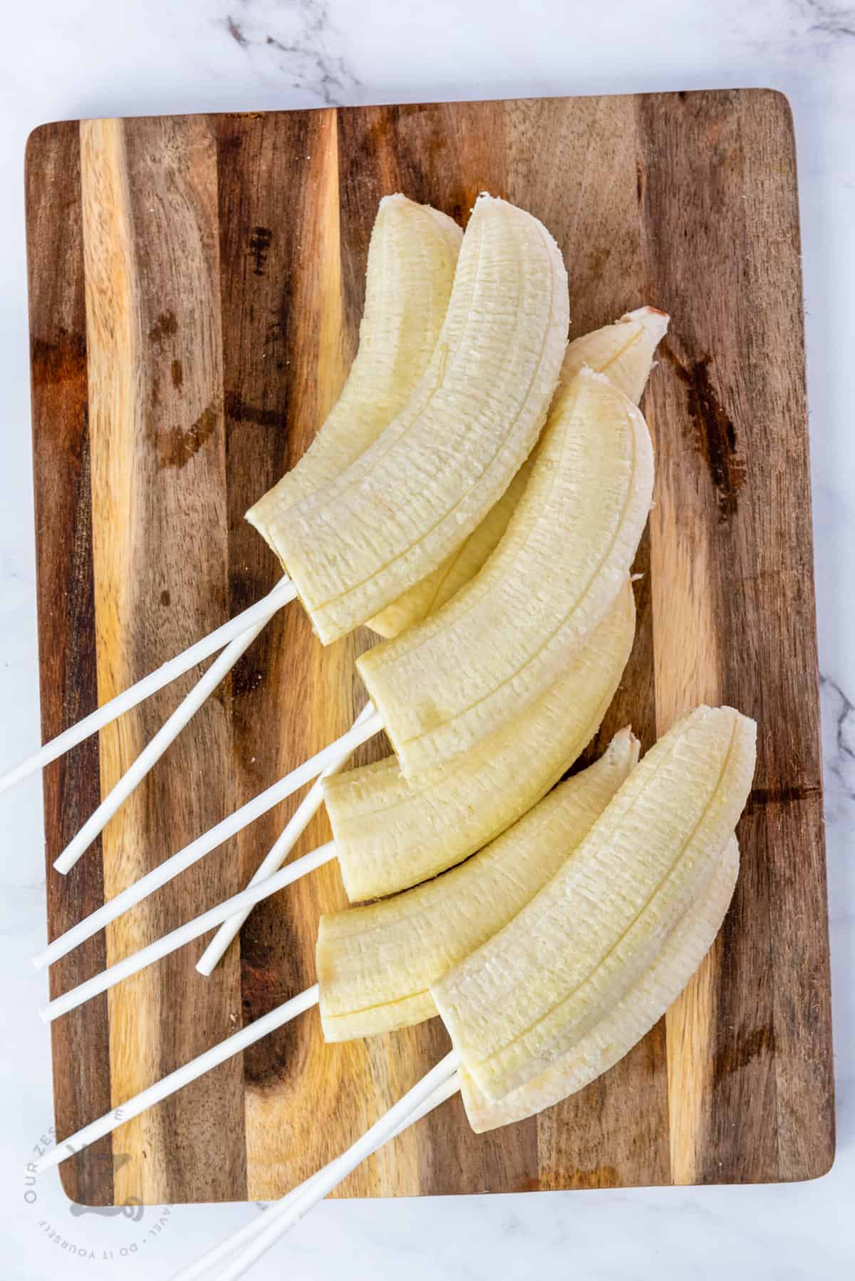 bananas on a stick to make Chocolate Dipped Bananas