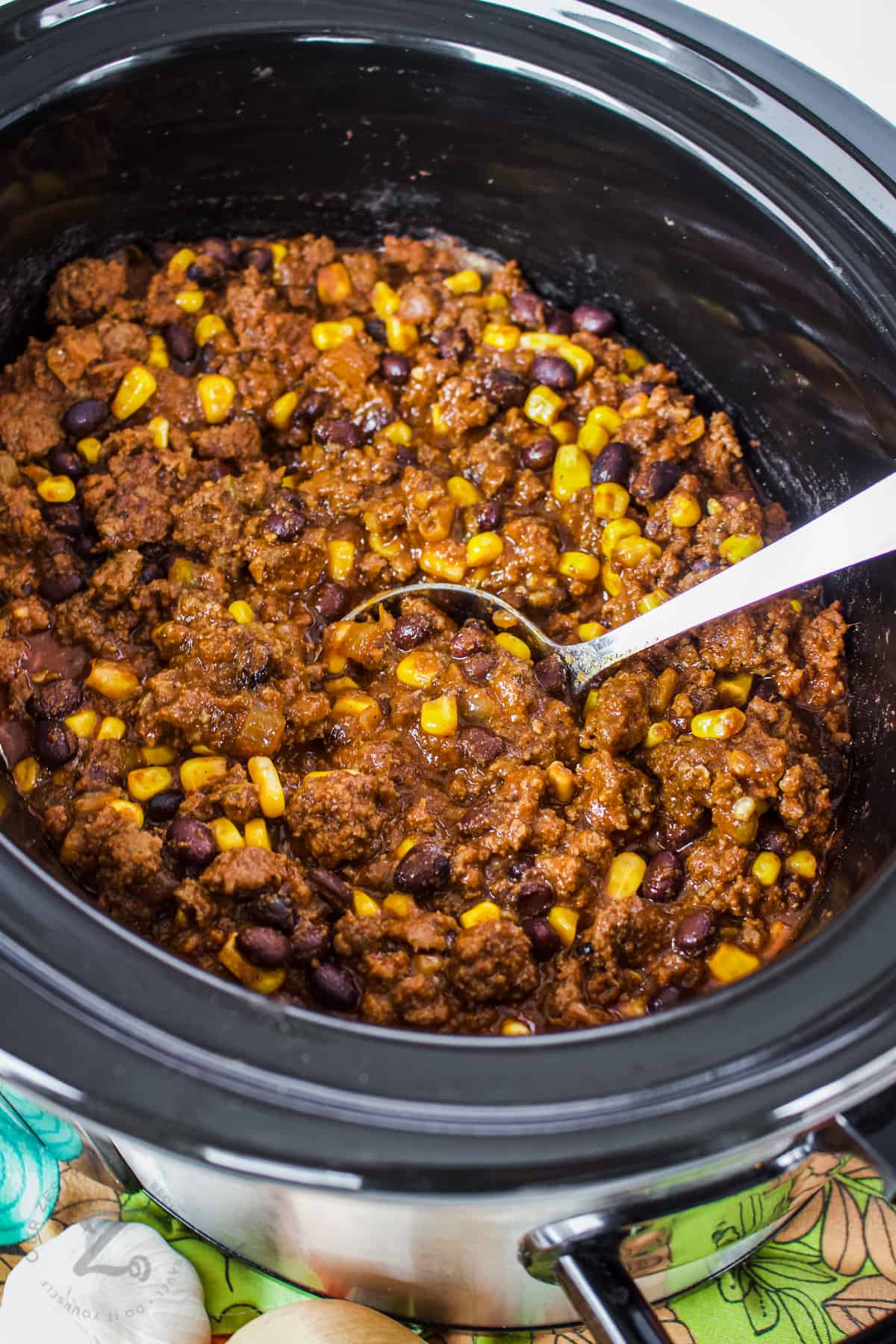 Easy Crockpot Black Bean Chili in the crockpot with a spoon