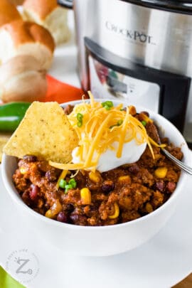 Easy Crockpot Black Bean Chili in a bowl with sour cream and cheese