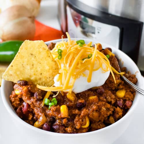 Easy Crockpot Black Bean Chili in a bowl with sour cream and cheese