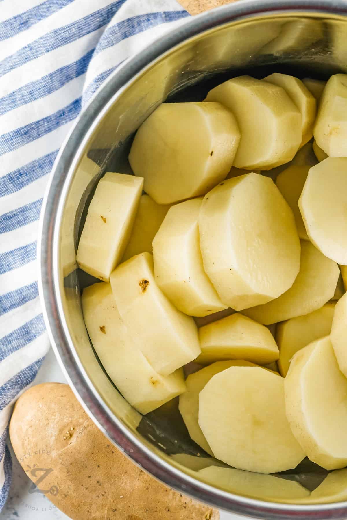 peeled potatoes in a pot to make Instant Pot Mashed Potatoes
