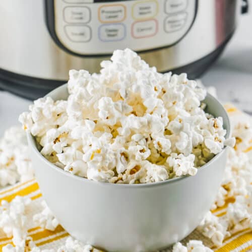 bowl of Instant Pot Popcorn with instant pot in back