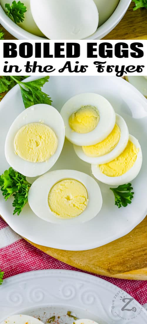 Air Fryer Boiled Eggs sliced on a plate with writing