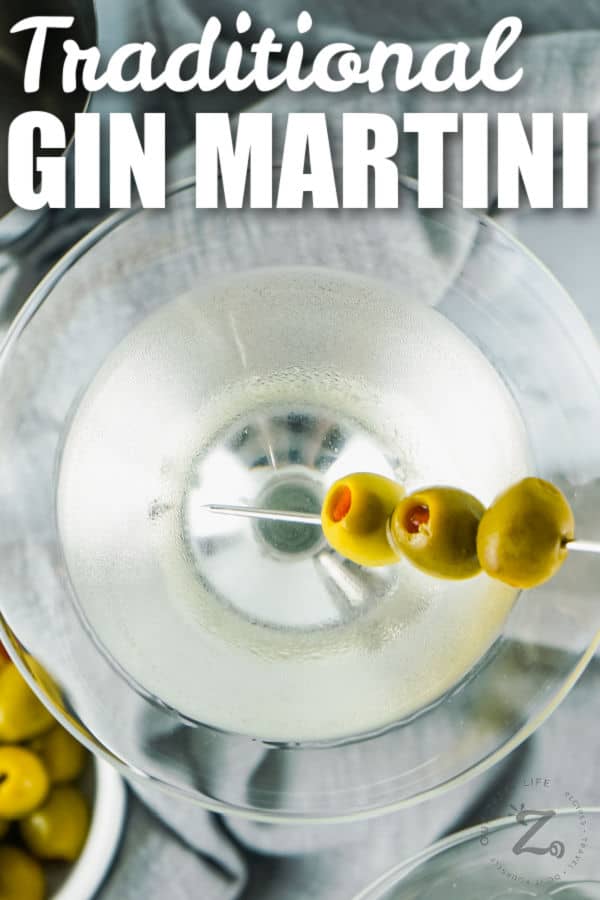 close up of Traditional Gin Martini with olives and writing