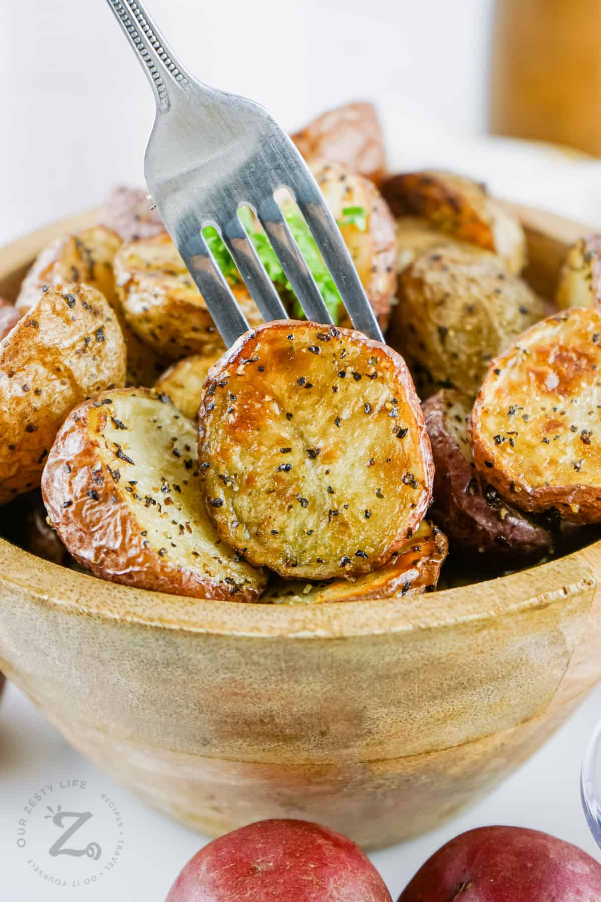 Air Fryer Roasted Potatoes in a bowl with a fork