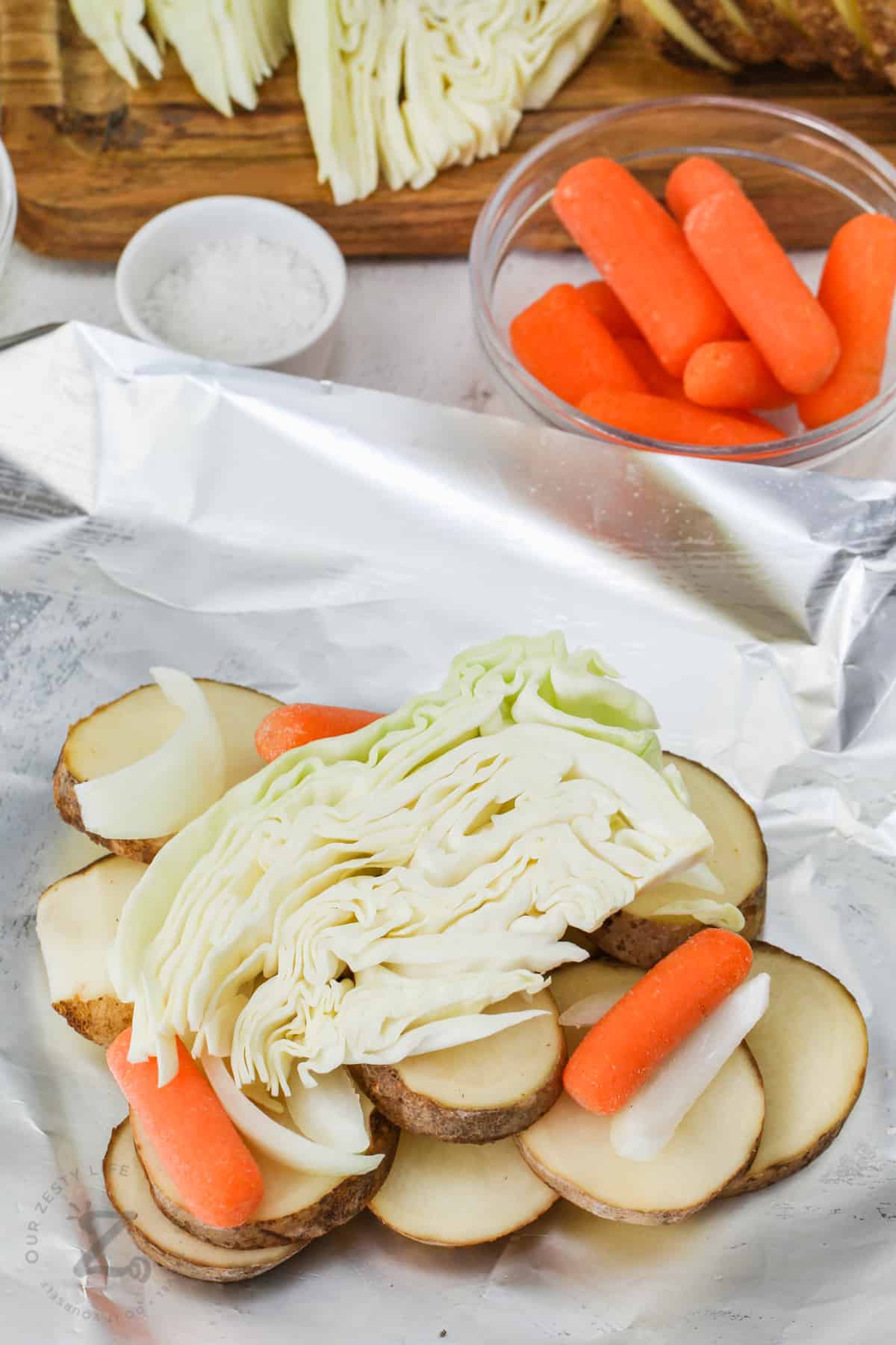 adding cabbage to foil to make Cabbage and Potato Foil Packs