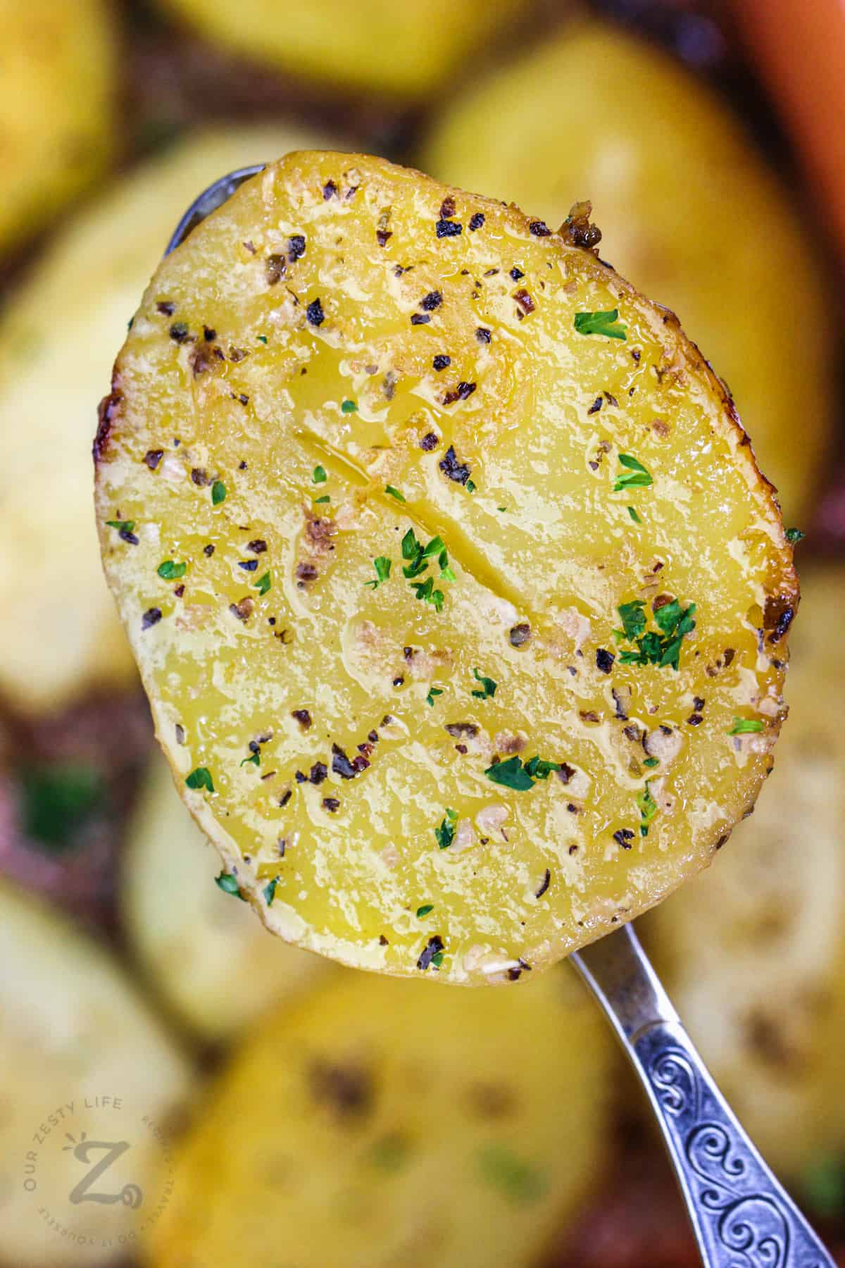 close up of Greek Style Lemon Potatoes on a spoon