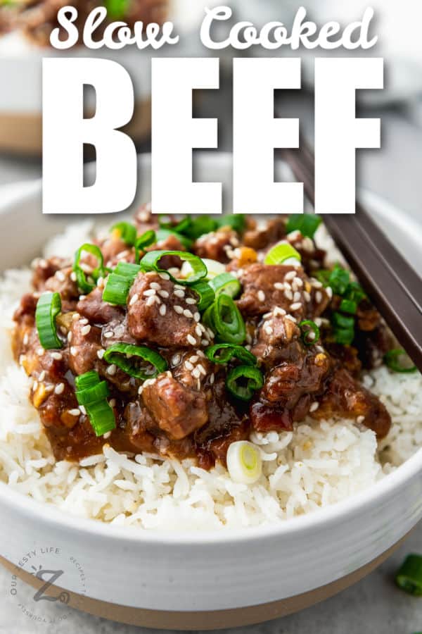 close up of Slow Cooker Mongolian Beef with rice and green onions and a title