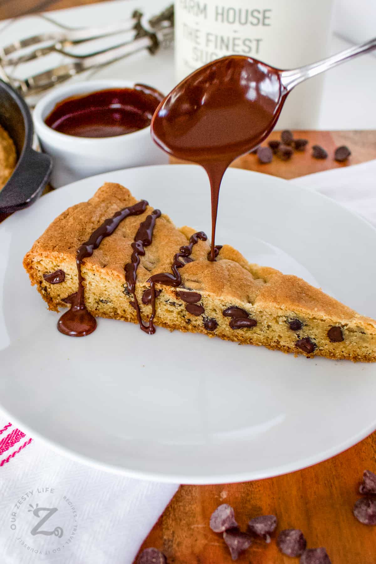 adding chocolate drizzle to Skillet Cookie Recipe