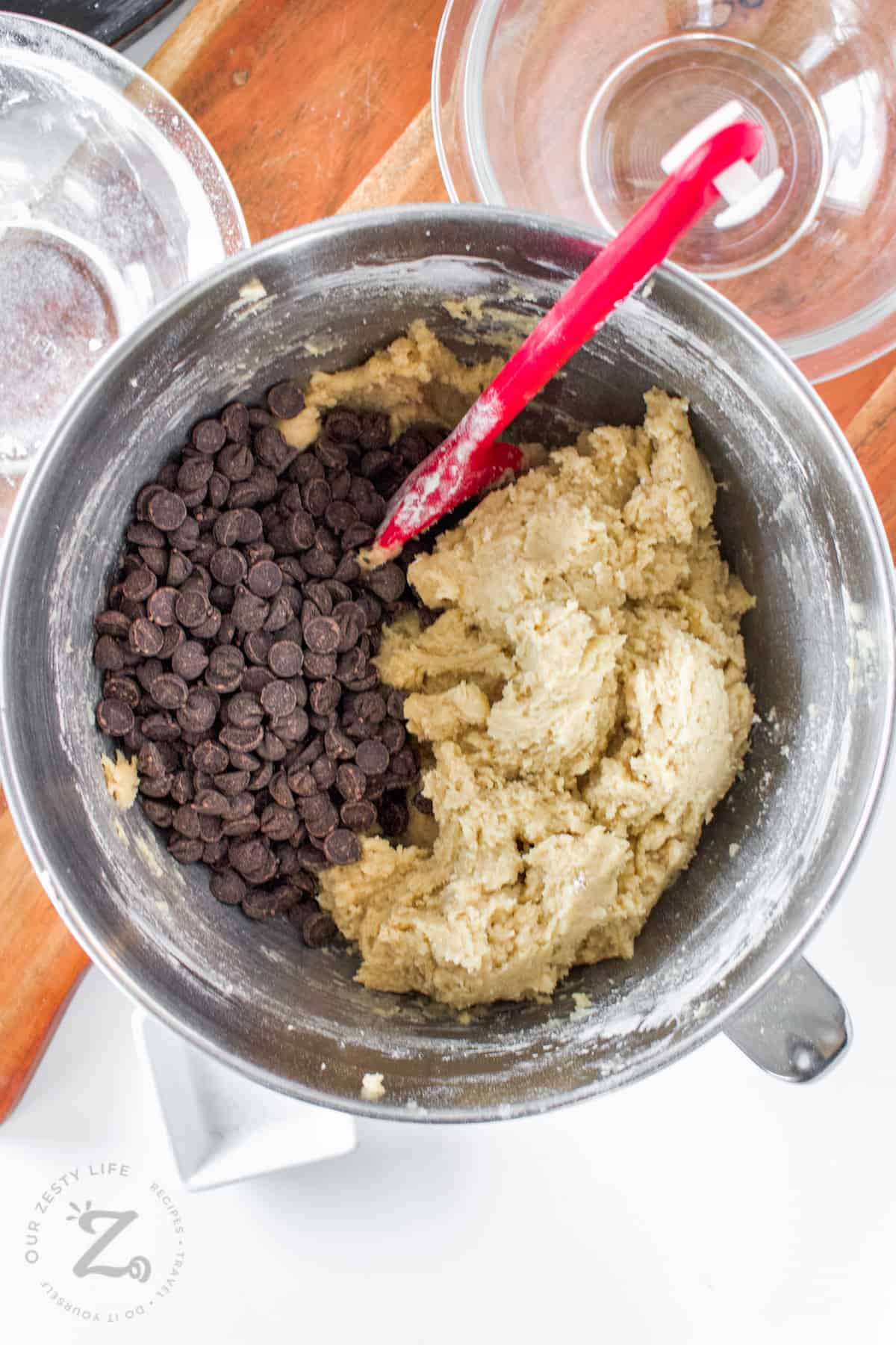 adding chocolate chips to bowl to make Skillet Cookie Recipe
