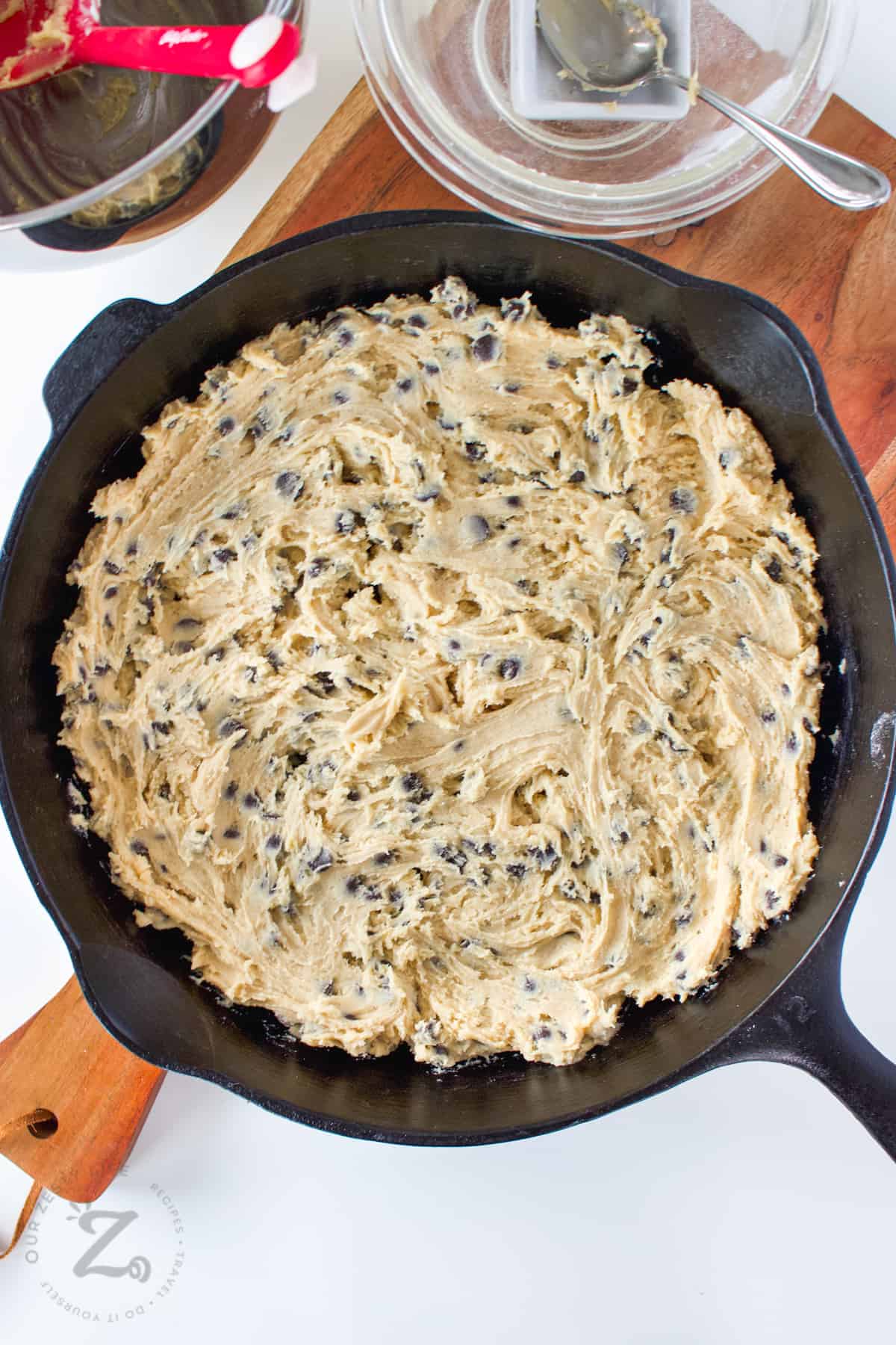 flattening Skillet Cookie Recipe dough into pan